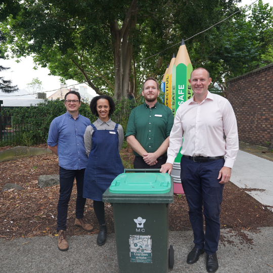 Mayor, councillor and teachers at a school with green bin